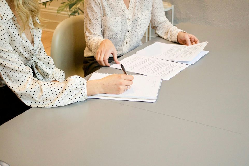 Client signing documents with an adviser