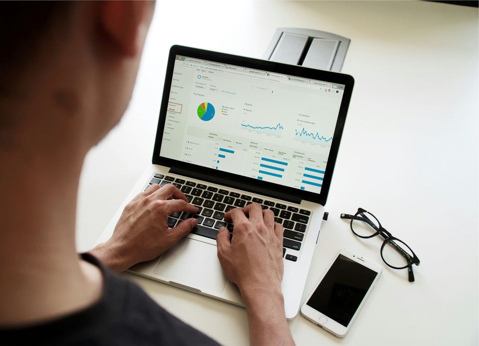 Person reviewing financial charts on a laptop
