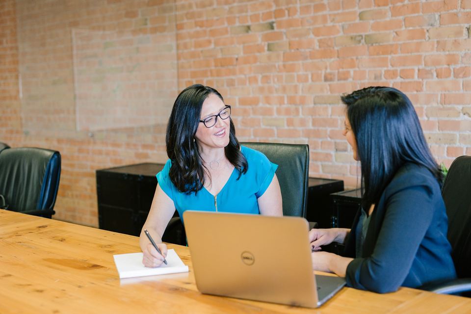 Colleagues working together at a laptop