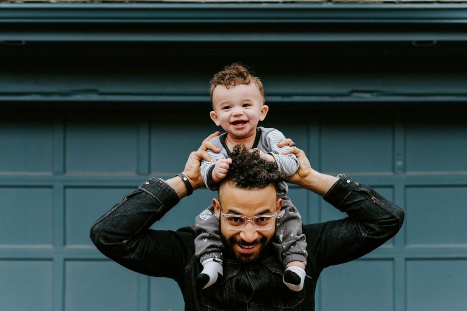 Father carrying his young son on his shoulders